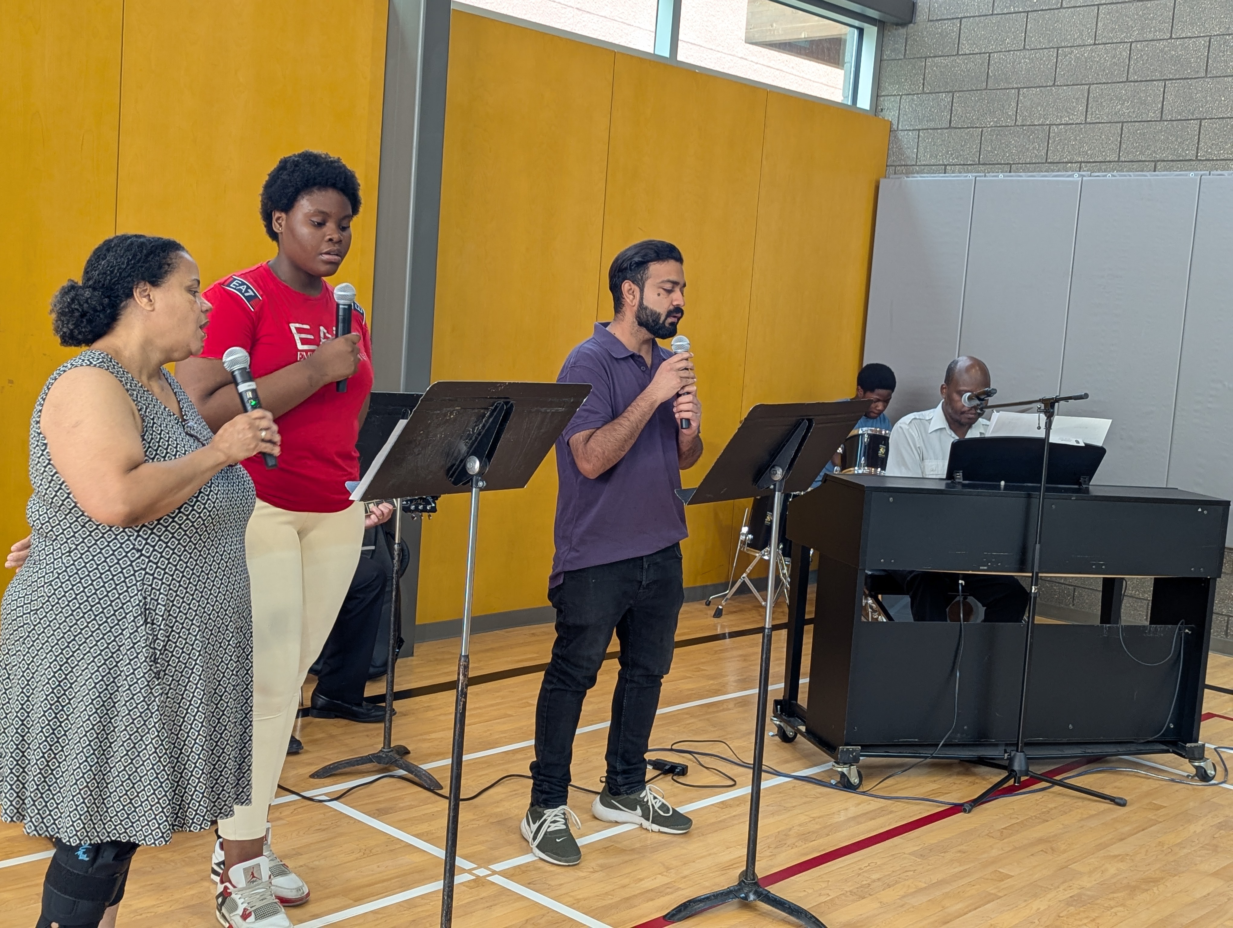 volunteers signing hymns and playing band