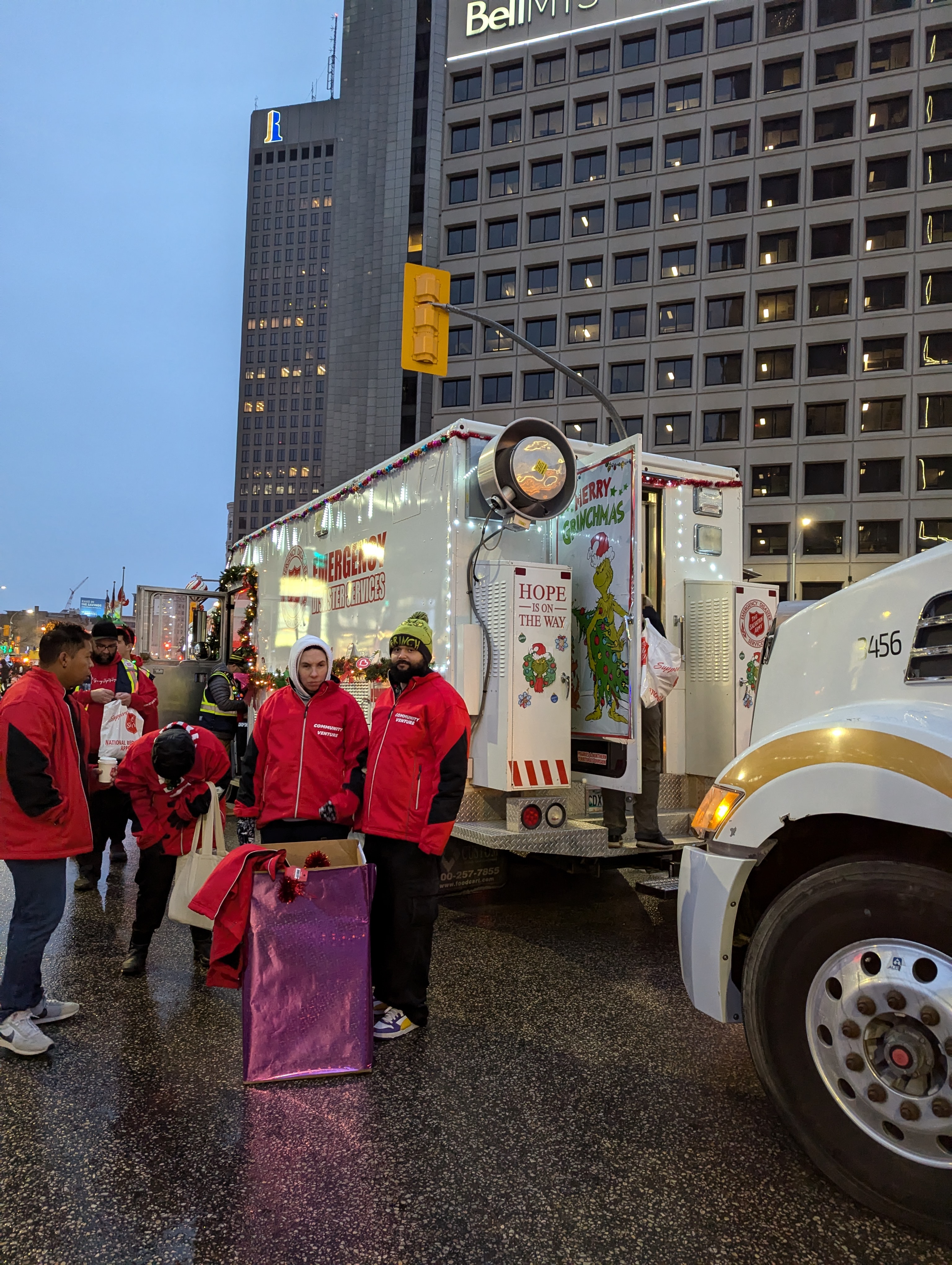 A group of LHCC employees and volunteers putting on red branded tops at the night in the city program
